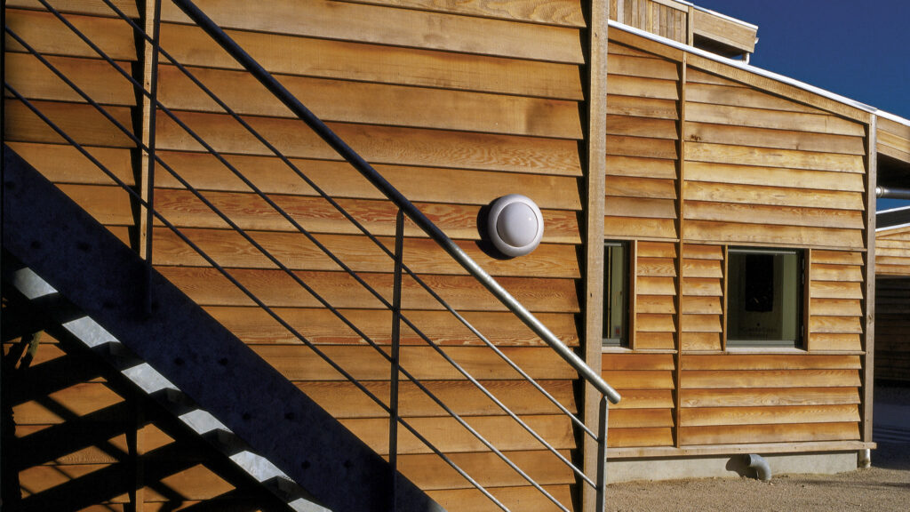 DOT L301 wall light from Lampas is seen on a wooden wall